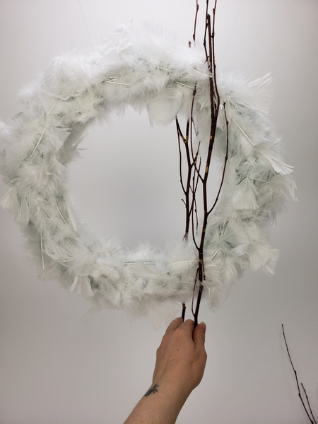 Slip a branch around the wreath so that you have twigs at the front and back