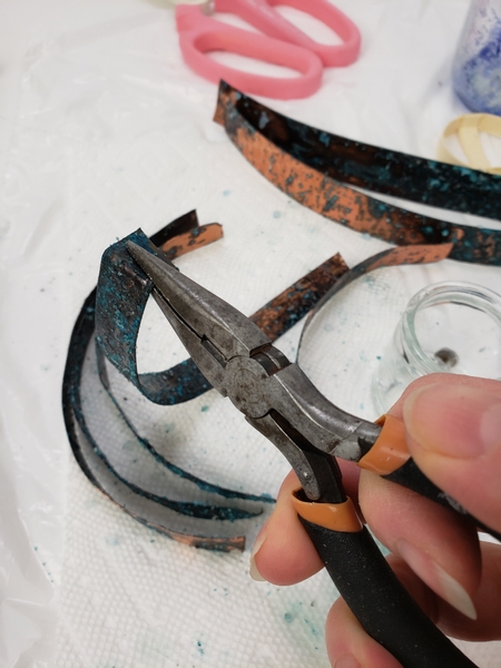 Use your pliers to curve one end flat