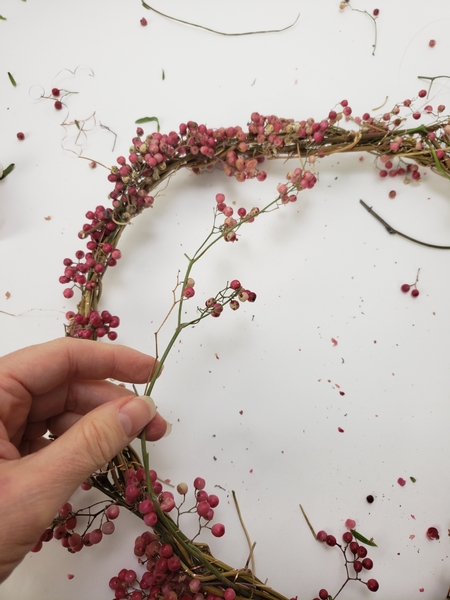 Weave in a few dangling branches every here and there to break up the wreath shape a bit