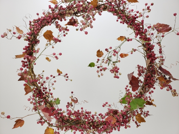 Weaving a pepper berry wreath for Autumn