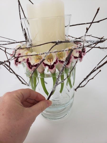 Glue in a few snow covered twigs to create a collar around the vases.