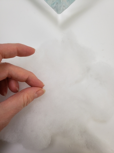 Fluff out foam filler or cotton wool to create a thin layer to cover the candles