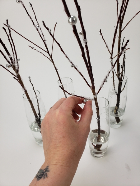 Glue in a few shiny beads to reflect the light onto the twigs