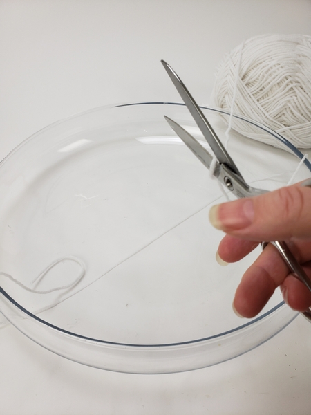Measure and cut wool to wrap around a shallow container