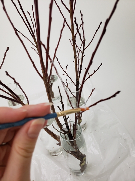 Paint the twigs with wood glue