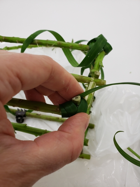 Turn the basket over and add grass from all the corners to inside the basket