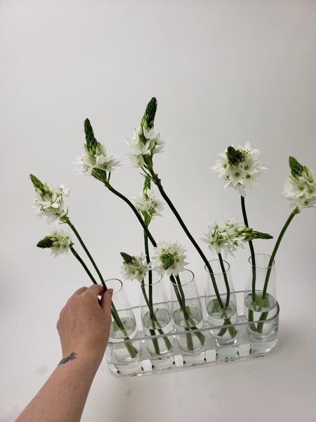 Add your flowers into the bud vases