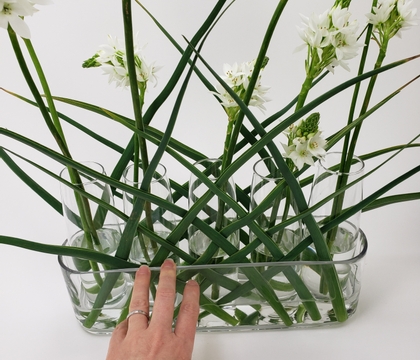 Connect bud vases with a fresh foliage open weave