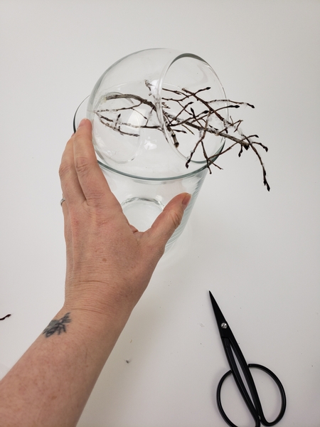 Continue to glue in twigs so that it spills out of the container
