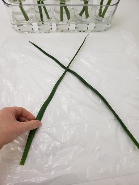 Cross your foliage on a flat working surface to start the weave