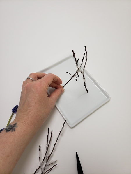 Lean the twigs to one side and secure them with glue