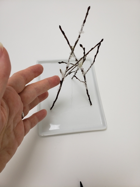 Once secure tap the design from all sides to make sure it stands securely before adding any more twigs or heavy flowers Once secure tap the design from all sides to make sure it stands securely before adding any more twigs or heavy flowers