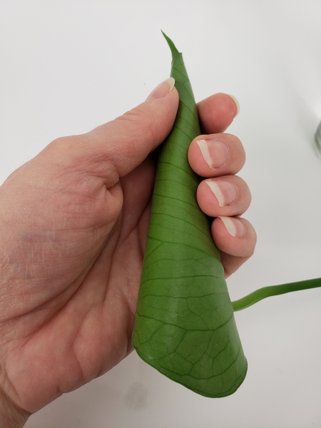 Hold the foliage in your hand for a few seconds for the glue to set