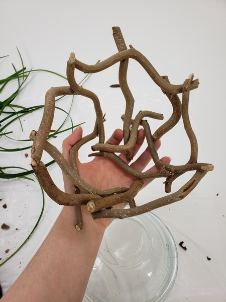 Turn the basket frame around and glue in more twigs to get the exact shape you want