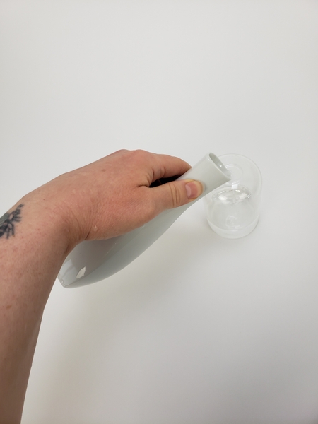 Fill a glass container with water Fill a glass container with water