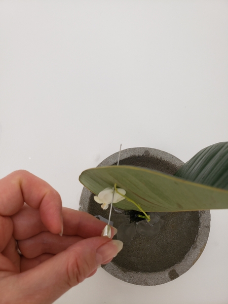 Pierce a pin through the leaf to mark the top of the flower