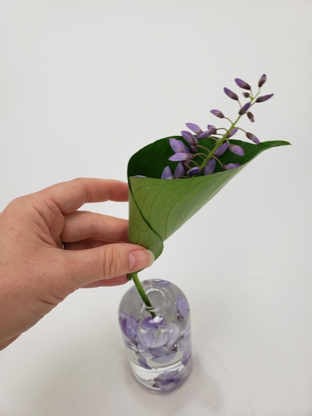 Place the stem into the flower filled vase