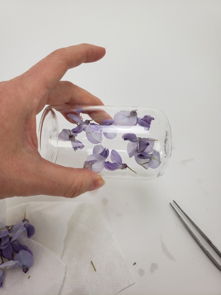 Roll the container while you add the flowers so that they can be placed all round