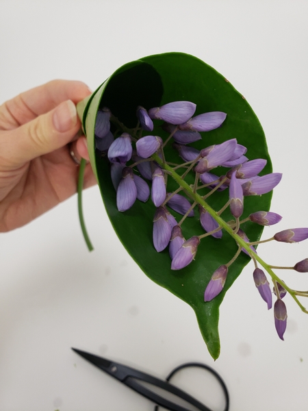 Slip a wisteria flower spike through the hole.