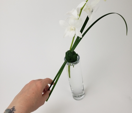 Weave a grass sphere to keep the long flower stems neatly in place on a bud vase