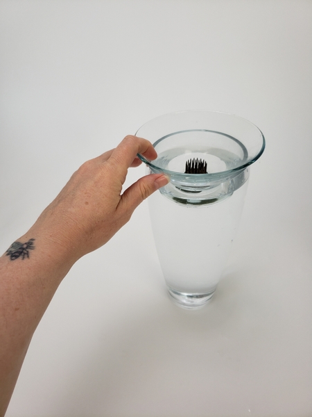 Fit the shallow container on the tall vase to make sure the water wont spill out