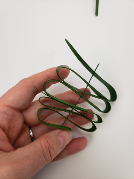 Fold the blade of grass and secure it with wire