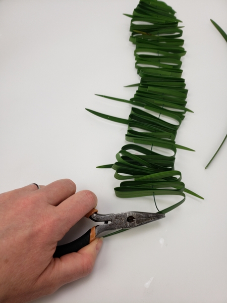 Fold the sharp end into a stopper with your pliers