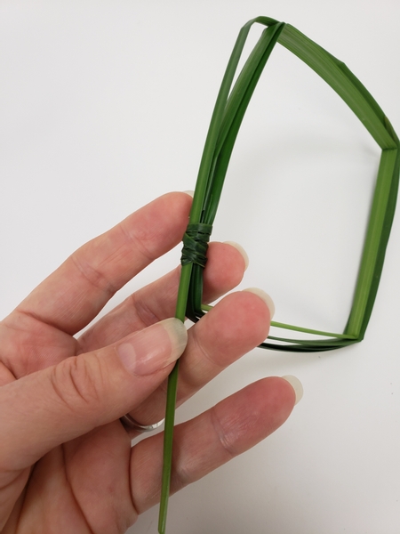 Thread the grass end through the knot to secure