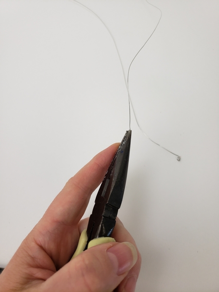 Twist the wire on one end to create a stopper