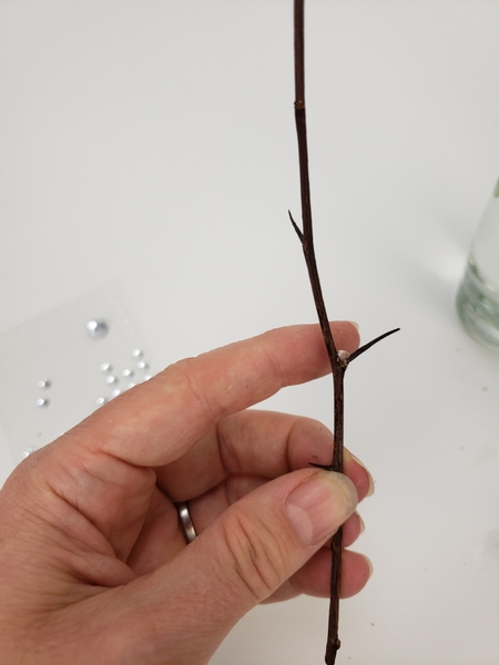 Add the tiniest drop of hot glue in the fork of a twig