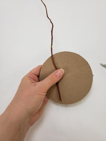 Place a pliable stem on the cardboard shape