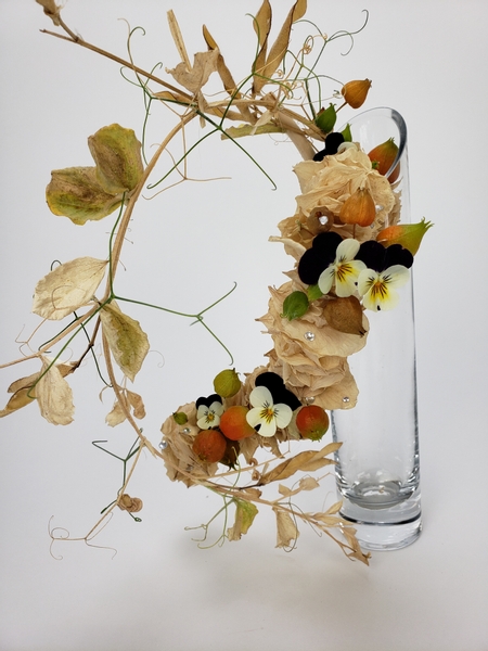Thread faded foliage into a flower arranging armature with wire