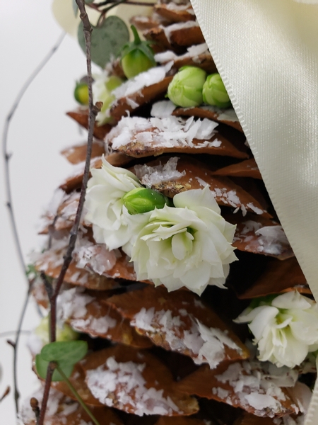 Elegant white Christmas styling with pinecones