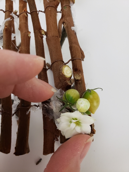 Glue in berries and kalanchoe flowers on to the sleigh
