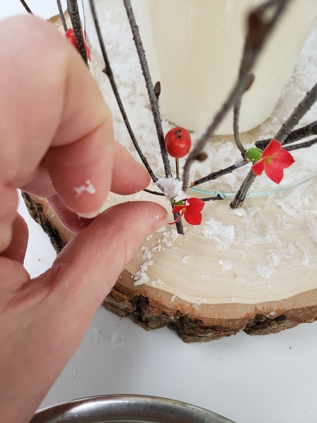 Place some artificial snow on the twigs