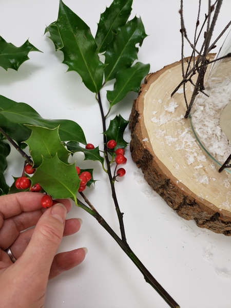Snip holly berries from the branch