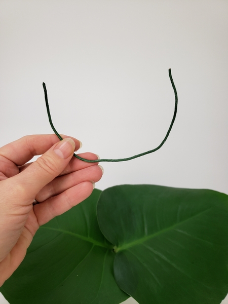 Cut the wire to fit halfway up each leaf and bend it into a u shape