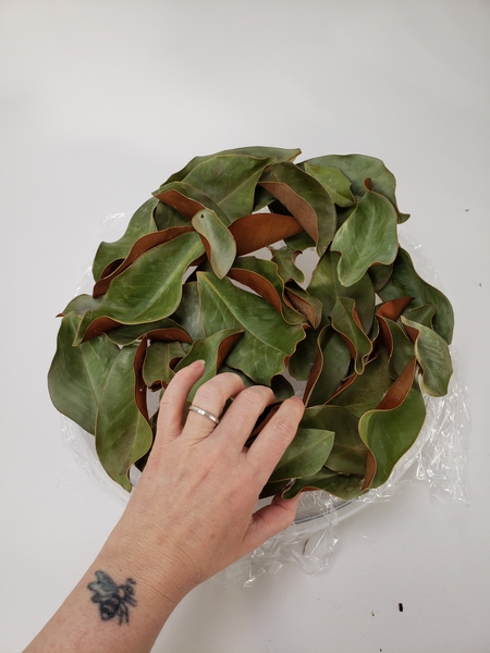 Glue in leaves until you have a pretty circular shape