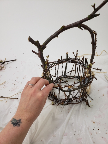Add a few more twigs with a few more drops of glue all the way around the basket