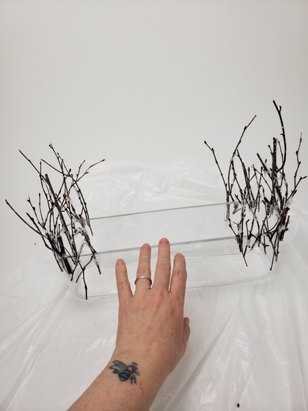 Crafting two u shaped winter twig armatures on  either side of the acetate platform