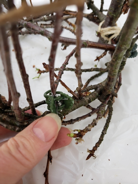 Create a flat bottom for the basket by bending the twigs into place