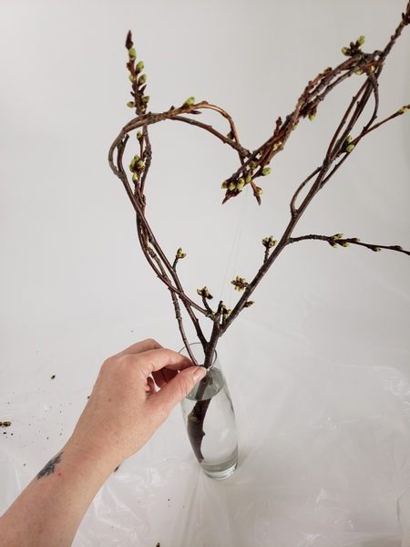 Place the twig heart in a bud vase filled with water