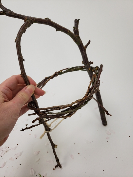 Slip the first wreath over the twig handle