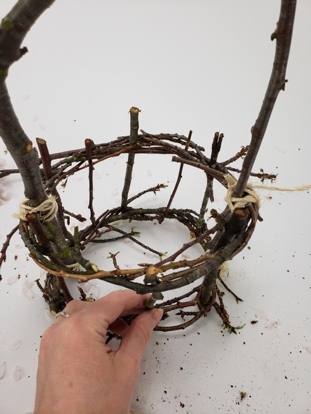 Weave in twigs through the top wreath down to the bottom wreath