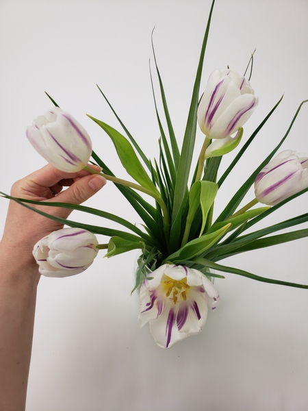 Add the tulips to spiral with the leaves.