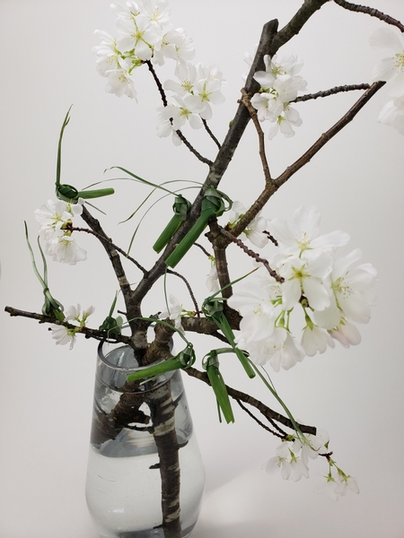 Weaving and folding grasshoppers for a Spring blossom branch design