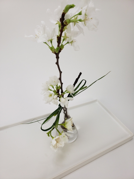 Paper flowers and real blossoms in a floral design