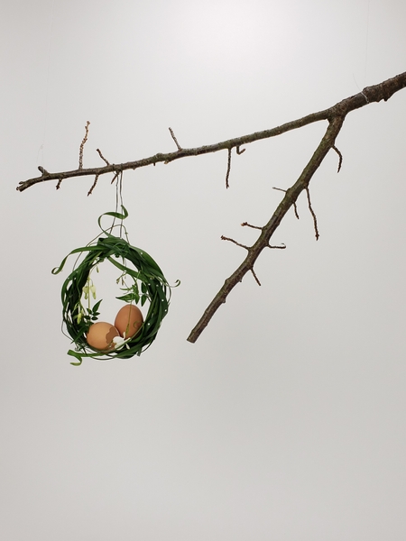 Hanging a fresh wreath for Easter with bleeding heart flowers and jasmine vine