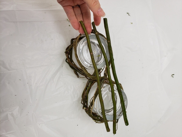 Space out the willow stems so that the glasses will rest on this when turned upright