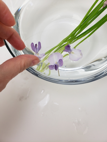 And start to float the flowers around the chives